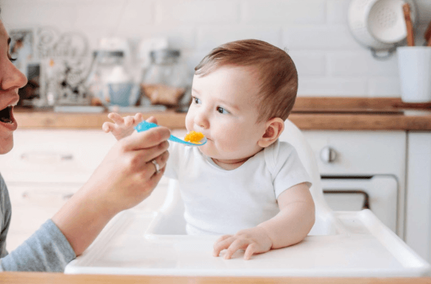 Photo: gradual complementary feeding of an infant